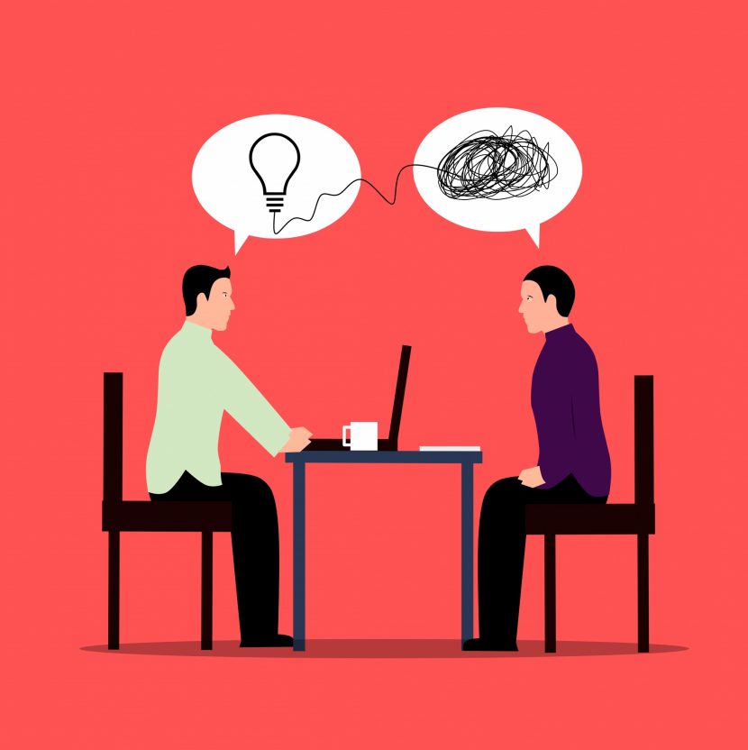 Two people sitting in chairs at a table, across from each other. A speech bubble above both of their heads. The one on the left has a lightbulb inside, and the one on the right has a tangled up black line.